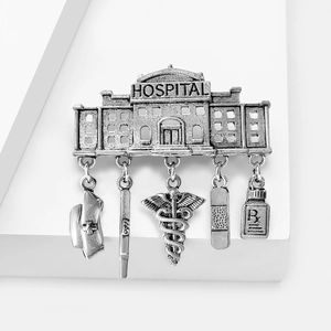 Vintage medical hospital brooch with nurse hat and Caduceus charms on white stand