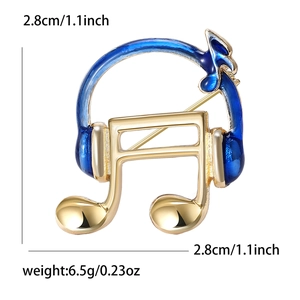 Macro view of gold-plated music note brooch with blue enamel inlay and dimensions