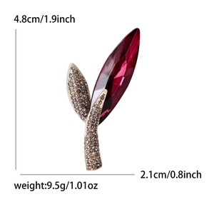 Elegant leaf brooch with ruby-tone faceted crystal and champagne rhinestones in gold setting