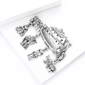 Detailed macro view of retro silver Noah's Ark brooch with animal charms on white stand