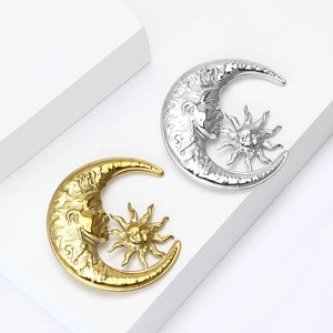 Polished celestial sun and moon metal brooches in gold and silver finishes