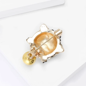Elegant gold Chinese style lion head brooch with round bead pendant and safety pin back