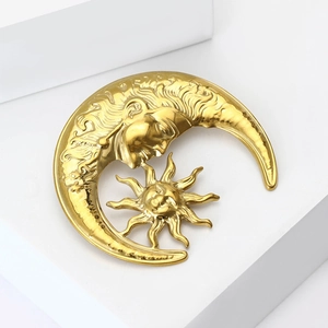 Minimalist gold moon and sun brooch with celestial textured face design in gold finish