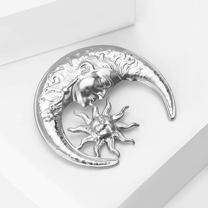 Silver liquid metal sun and moon brooch pin with vintage relief details on white stone