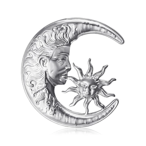 Minimalist silver moon and sun brooch with celestial textured face design on white background