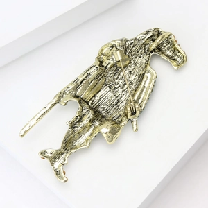 Detailed back view of vintage gold horse shield brooch showing pin clasp and metal texture
