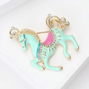 Macro detail of carousel horse brooch with mint enamel and crystal accents
