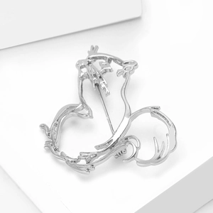 Detail showing the silver alloy hollow cat brooch with a metal pin clasp on the back