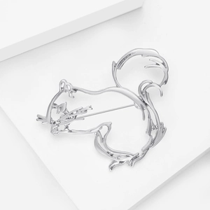 Macro shot of silver alloy squirrel brooch with hollow design and smooth metallic finish