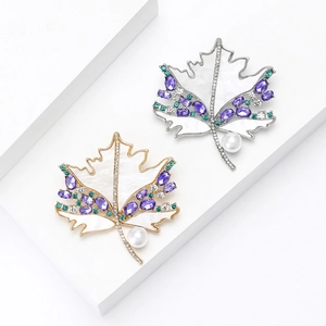 Elegant maple leaf brooch with natural shell, purple zircon and pearl in gold and silver