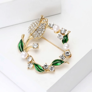 Elegant gold tulip wreath brooch with pearls, crystals, and green enamel leaves