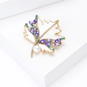 Close-up of maple leaf brooch with mother of pearl finish, purple zircon and white pearl