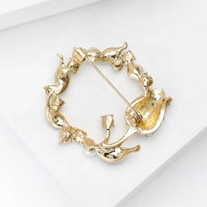 Elegant gold tulip wreath brooch with fine textures and pearl details on white stand