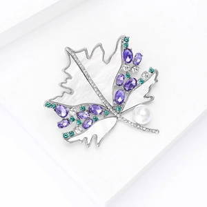Detail of maple leaf brooch with purple gemstone, white pearl and micro-pave zircons