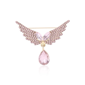 Elegant gold angel wing brooch with pink crystal pendant on white background