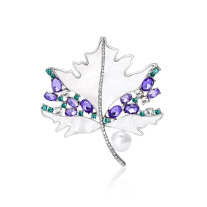 Elegant maple leaf brooch with natural shell, purple crystals, and a white pearl accent