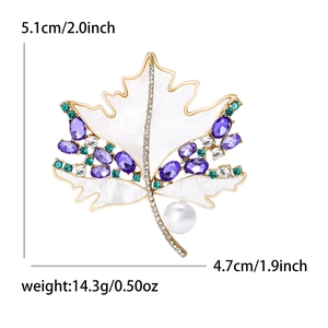Elegant gold maple leaf brooch with purple shell and pearl, measures 5.1cm by 4.7cm
