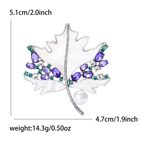 Elegant maple leaf brooch with shell luster, purple crystals, and a round pearl inlay