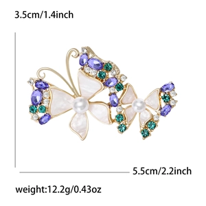 Elegant gold butterfly brooch with purple gems, white pearls and shell wings inlay