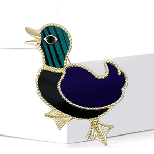 Fashionable duck brooch with gold frame and striped enamel detail on white base