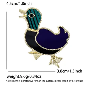 Cartoon duck animal brooch with green striped head and golden accents on white background