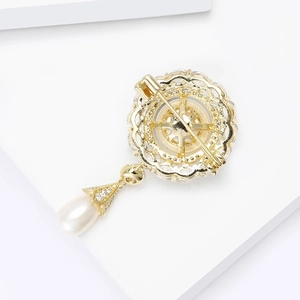 Vintage style gold-toned flower brooch with freshwater pearl and shimmering zircon stones