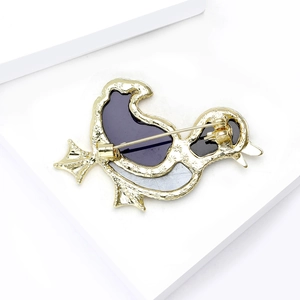 Back view of a gold duck brooch with purple enamel and a secure pin fastening mechanism