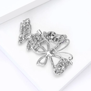 Detail view of the silver butterfly brooch back showing the pin and safety clasp