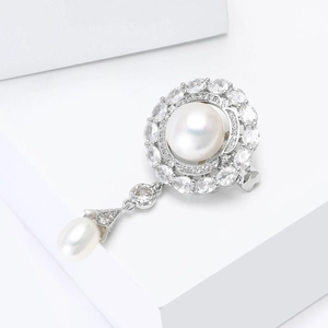Macro detail of royal flower brooch with freshwater pearl and sparkling cubic zirconia stones