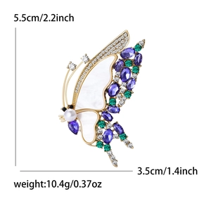 Broche papillon dorée élégante avec cristaux violets et incrustation de nacre