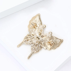 Elegant gold butterfly brooch with hollow shell inlay and sparkling diamond accents