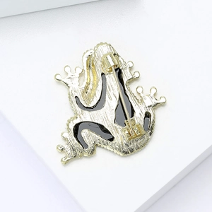 Rear view of gold-tone frog brooch showing the secure rotating pin and alloy texture