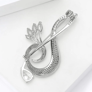 Detailed back view of a copper music note brooch showing the safety pin clasp mechanism