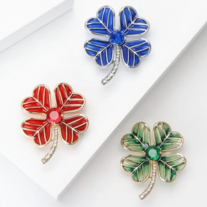Three-piece four-leaf clover brooch set in blue, red, and green with crystal inlay