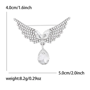 Silver angel wing brooch with clear crystals and a teardrop-shaped zircon pendant