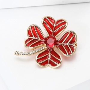 Detail of red clover brooch with enamel petals, gold finish and sparkling crystal stem