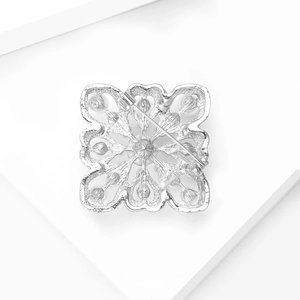 Macro detail of the silver hollow baroque brooch back with secure pin clasp closure