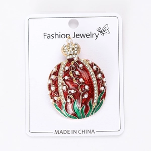 Detail of crown pomegranate brooch with red enamel, pearls and rhinestones