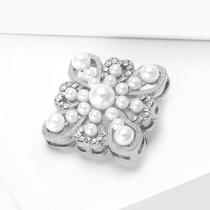 Detailed macro view of baroque pearl brooch with sparkling crystals in silver setting