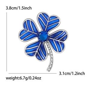 Blue enamel four leaf clover brooch with centered crystal and silver metal borders