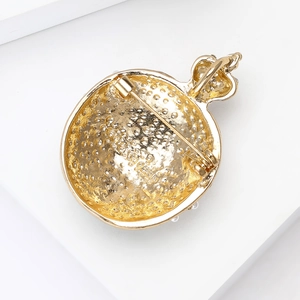 Back view of a gold crown brooch with a pearl diamond pomegranate and mesh design