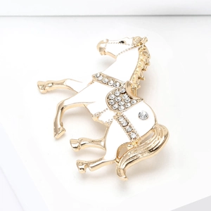 Macro detail of horse brooch with white enamel finish and shimmering rhinestones