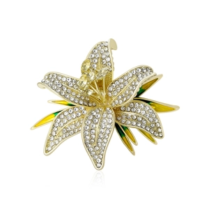 Elegant lily flower brooch in gold with pavé crystals and green enamel detail