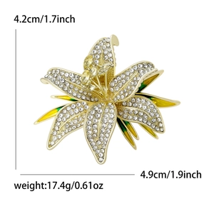 Elegant lily flower brooch with rhinestones and yellow green enamel in golden finish