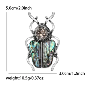 Broche scarabée vintage avec ailes en nacre d'abalone et cristaux brillants de 5x3 cm
