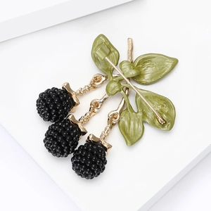 Exquisite blackberry fruit brooch with black berries and green leaves on a white background