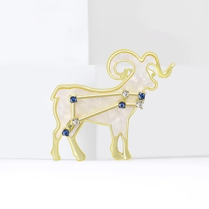 Minimalist gold Aries zodiac brooch with white enamel and blue crystal constellation
