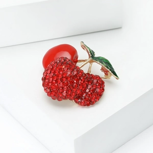 Sparkling triple cherry brooch with red rhinestones and green leaves on gold stems