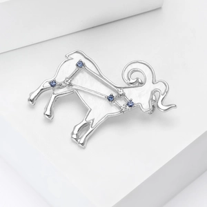 Macro detail of Aries constellation brooch with blue crystals and silver-plated finish