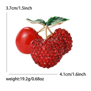 Cute red cherry brooch with sparkling rhinestones and green enamel on a gold base
